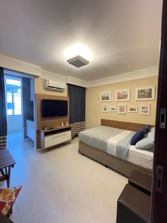 a bedroom with a bed and a flat screen tv at Rio de Janeiro Botafogo Zona Sul in Rio de Janeiro