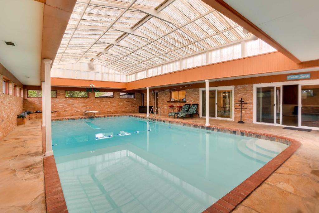 a large swimming pool in a large building with a ceiling at Indoor Pool Peaceful Oasis in Hitchcock! in Hitchcock