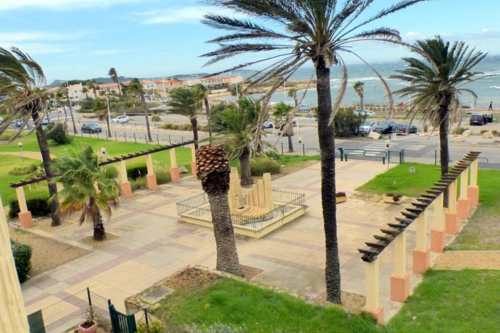 - une vue aérienne sur un parc planté de palmiers dans l'établissement Comfortable nest with pool facing the sea, à Six-Fours-les-Plages