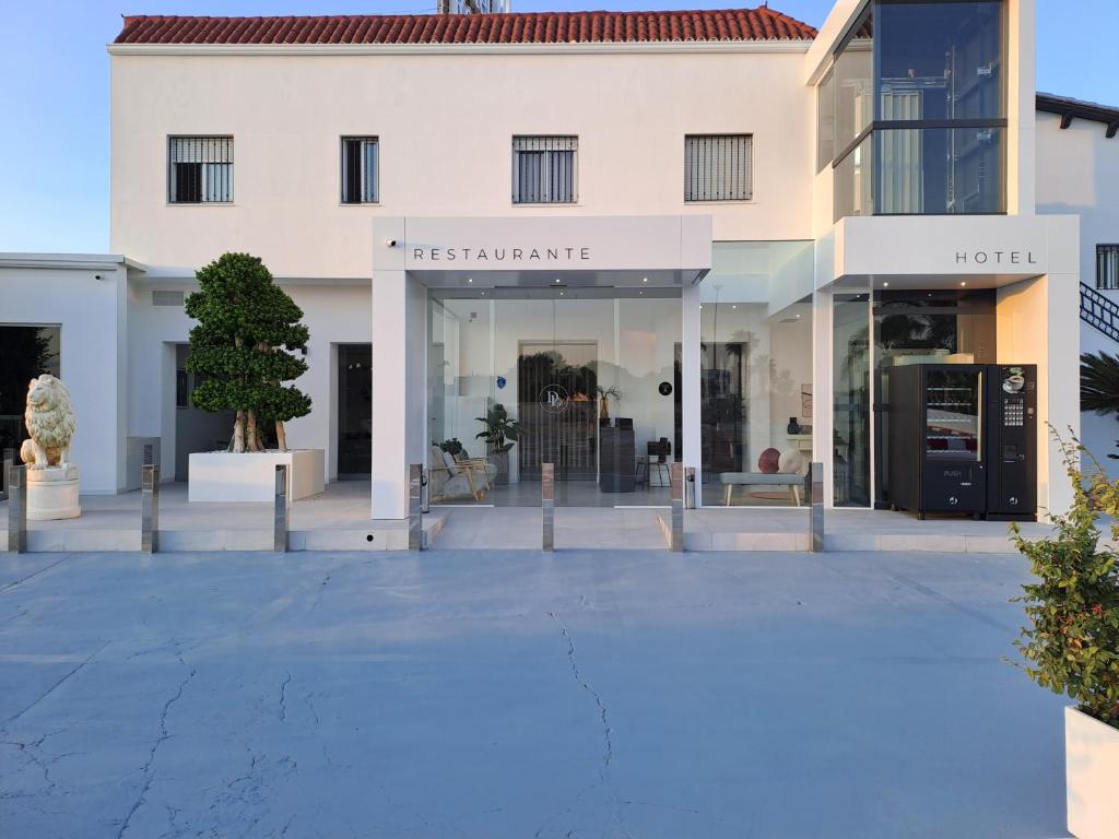 una tienda frente a un edificio blanco en DON LEONE Hotel, en Alginet