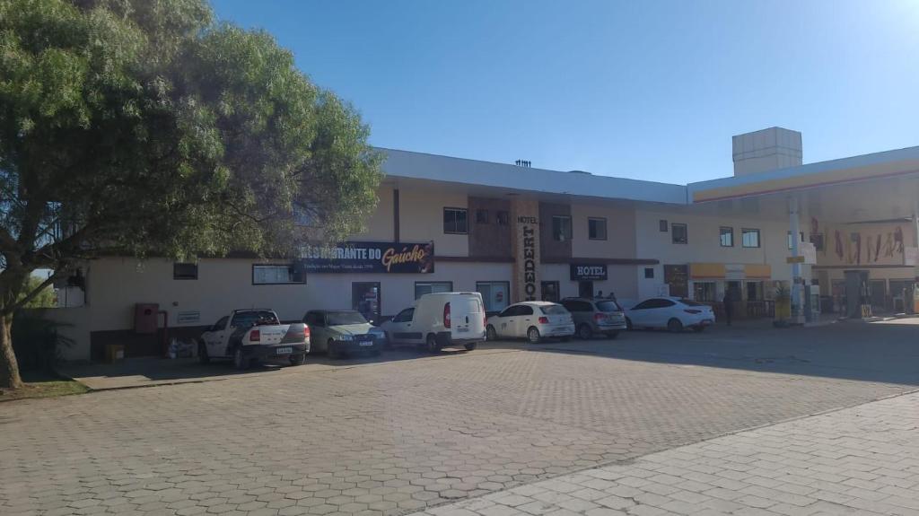 a building with cars parked in a parking lot at Hotel Goedert 