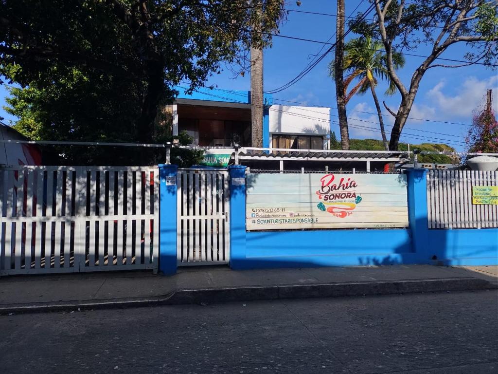 een blauw en wit hek aan de kant van een straat bij Posada Cultural Bahia Sonora in San Andrés