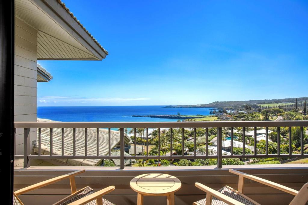 a balcony with chairs and a view of the ocean at K B M Resorts- KRV-2823 Large 1Bd with 180-degree ocean views perfect for whale watching in Kaanapali