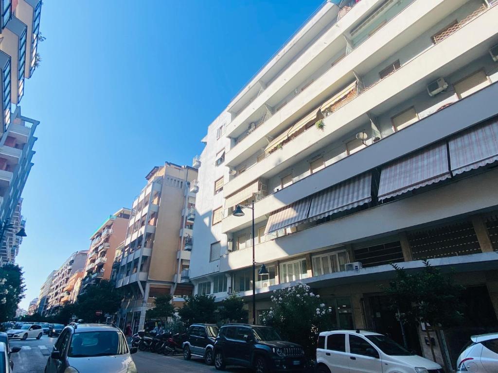 a city street with cars parked in front of buildings at Casa InCentro in Pescara