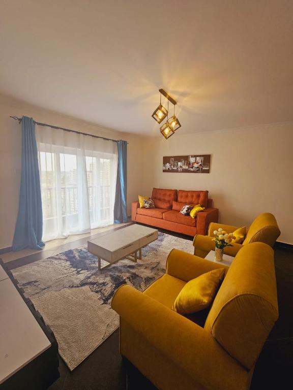 a living room with a yellow couch and a table at Mimi's Haven in Nairobi