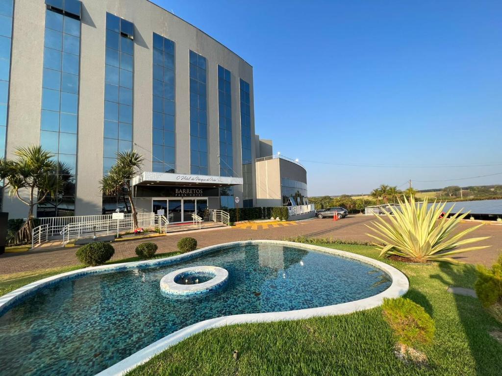 un edificio con piscina di fronte a un edificio di Condominio Barretos Thermas Park - Condohotel 1242 a Barretos