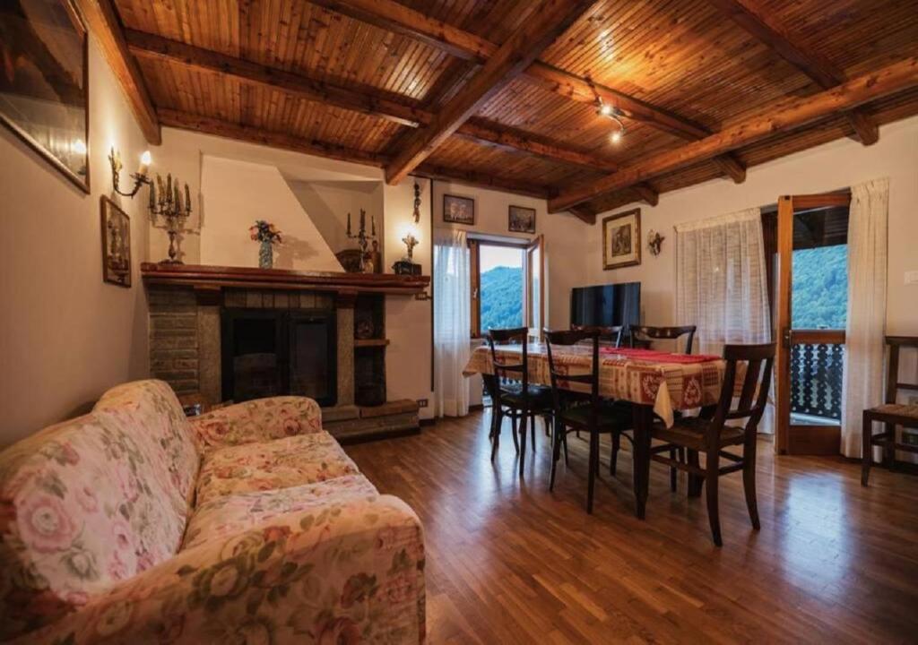 a living room with a couch and a dining room table at Ca d'Moreno in Viù
