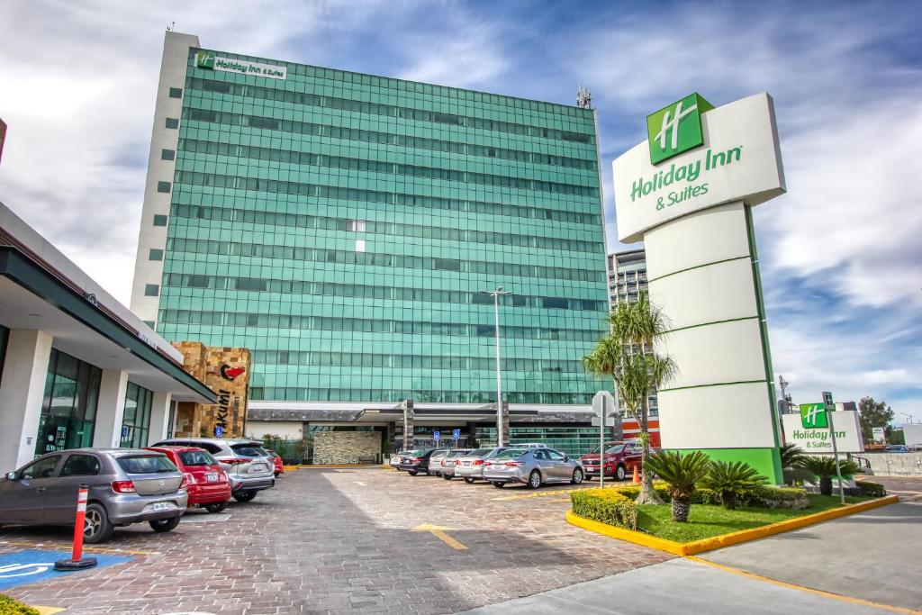 a parking lot in front of a building at Holiday Inn & Suites Plaza Mayor, an IHG Hotel in León