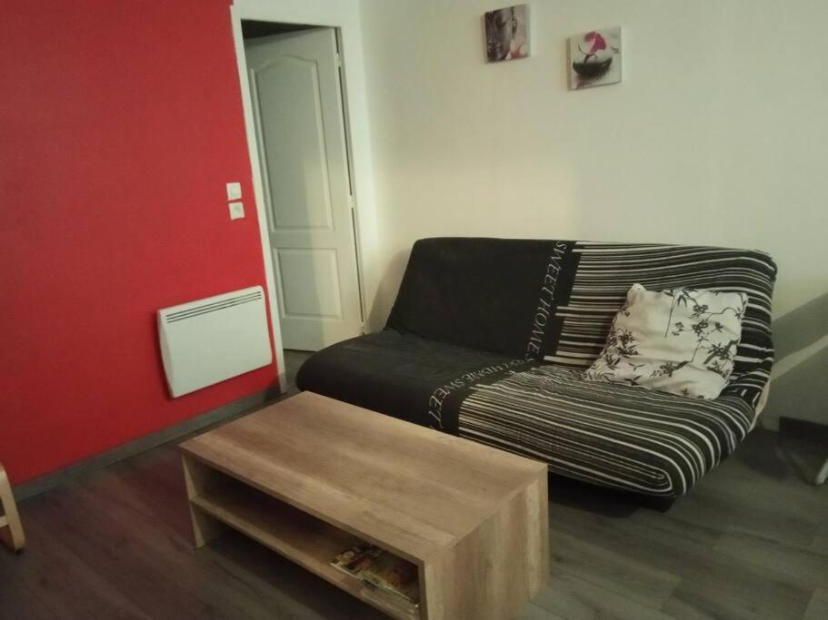 a living room with a couch and a coffee table at appartement Netflix parking gratuit climatisation in Saint-Ambroix