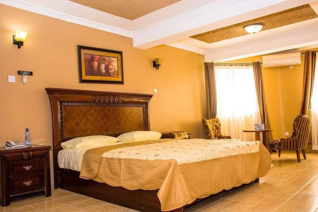 a bedroom with a bed and a table and a window at Tana Garden Hotel in Garissa