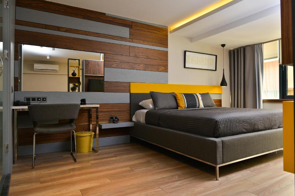 a bedroom with a bed and a desk at Spil Suites in Izmir