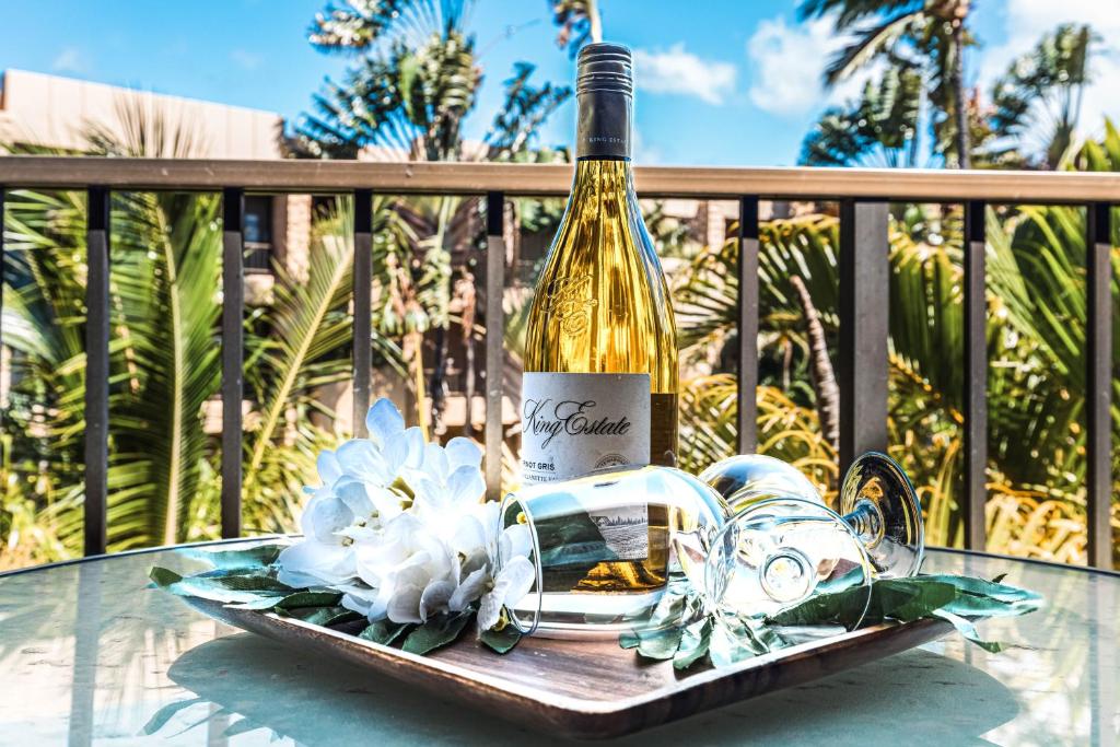 a bottle of wine on a tray on a table at Paki Maui 414 in Kahana