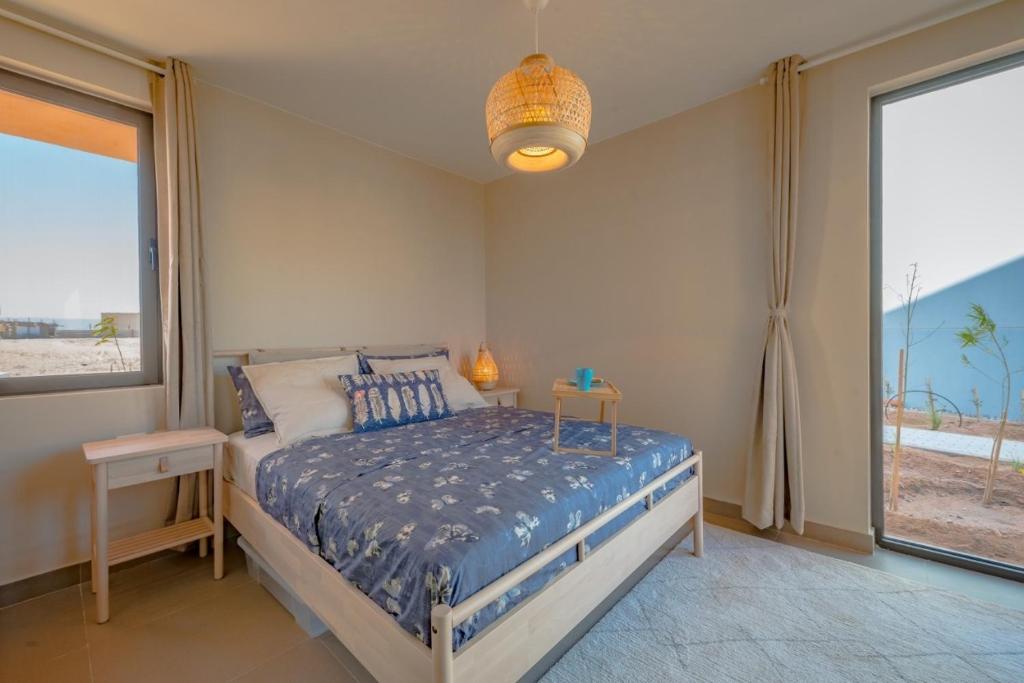 a bedroom with a bed and a large window at Apartment in Gouna Tawila The Butterfly in Hurghada