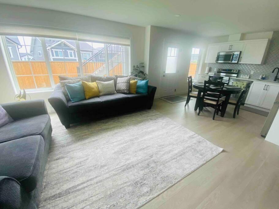 a living room with a couch and a table at The Royal Bay Escape: Cozy 2 bedrooms garden suite in Colwood