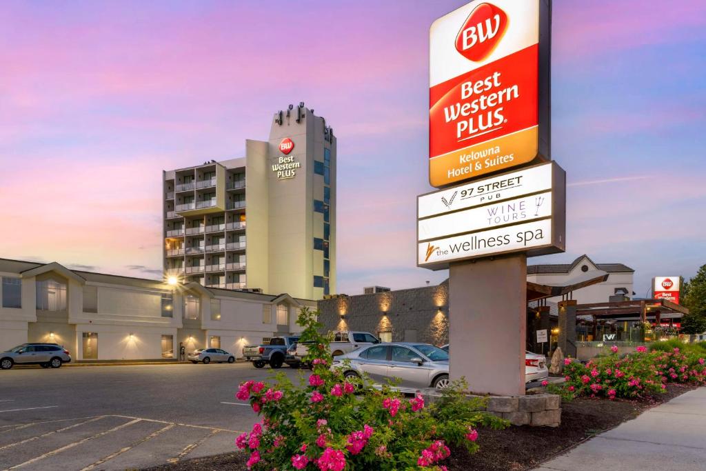 a sign in a parking lot in front of a hotel at Best Western Plus Kelowna Hotel & Suites in Kelowna