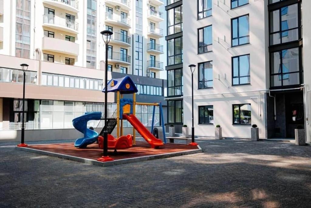 a playground in the middle of a street with buildings at CityView Apartment in Chişinău