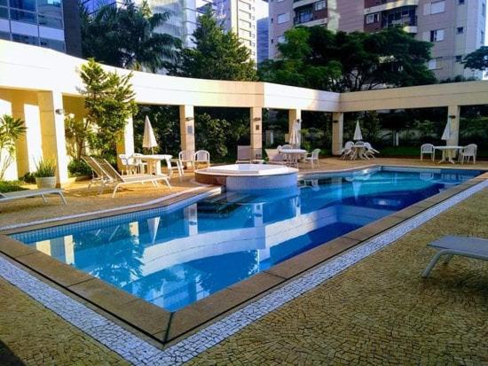 a swimming pool in the middle of a building at World Flat Hotel - Vila Olímpia in Sao Paulo