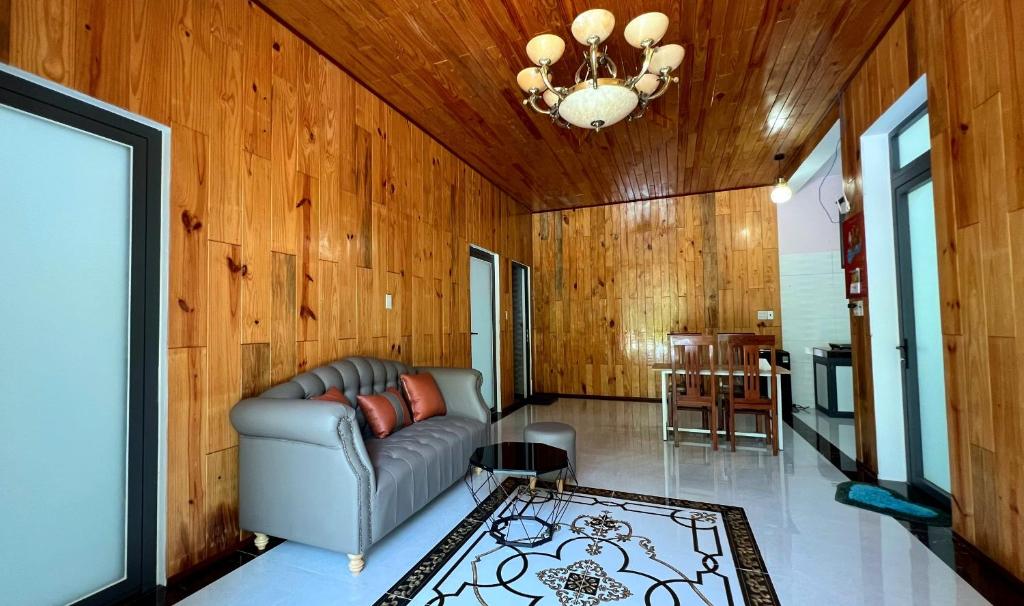 a living room with a couch and a table at Phu Nam House - Resort in Phú Quốc