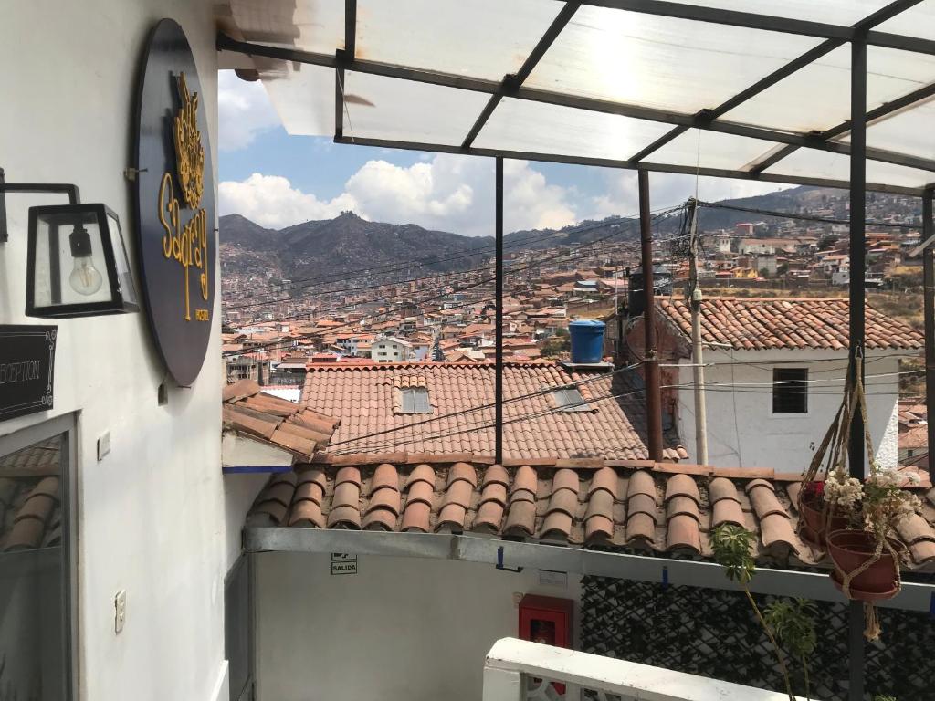 a view of a city from a building with roofs at Saqray Hostel in Cusco