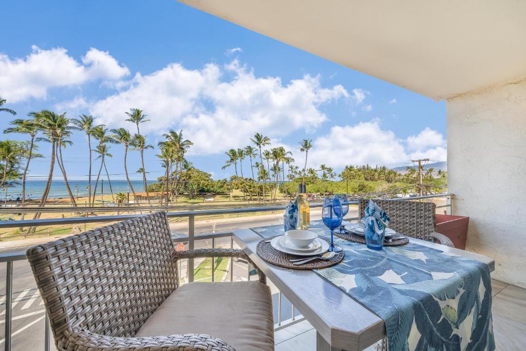 a dining table with chairs and a view of the ocean at Island Surf 306 in Kihei