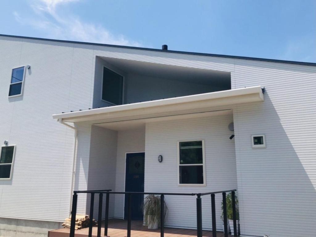 a white building with a black fence in front of it at SHIMAGO SURFRIDER - Vacation STAY 85442v in Amakusa