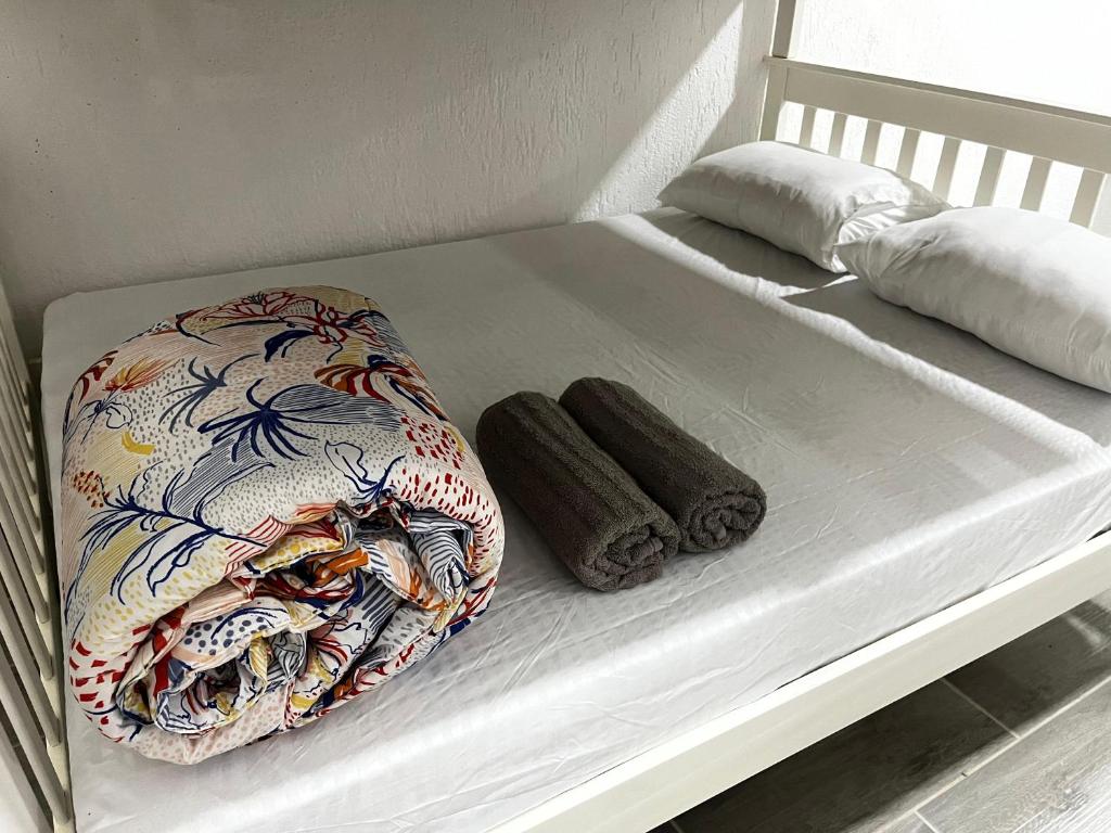 a bunk bed with two pillows on it at Meu Loft Barra Nova 3 in Saquarema