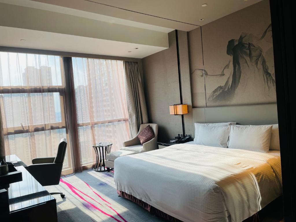 Postel nebo postele na pokoji v ubytování Maanshan Wanda Realm Hotel