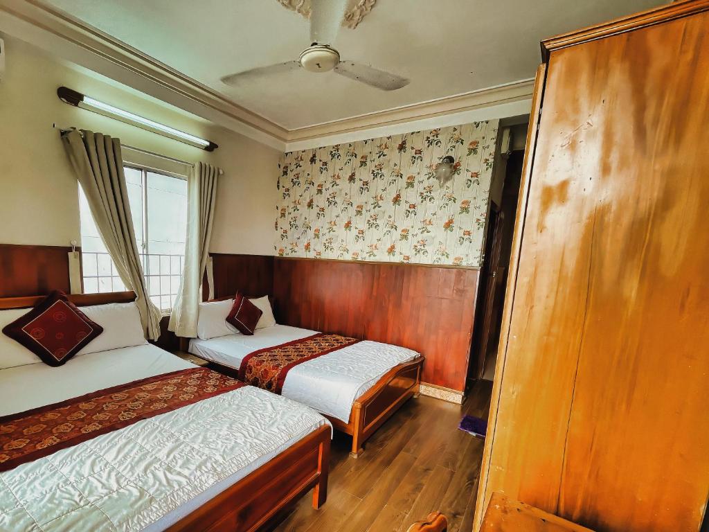 Postel nebo postele na pokoji v ubytování Quang Vinh 2 Hotel