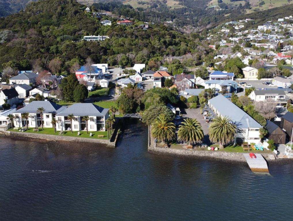 an aerial view of a small town by the water at Akaroa Waterfront Motels in Akaroa