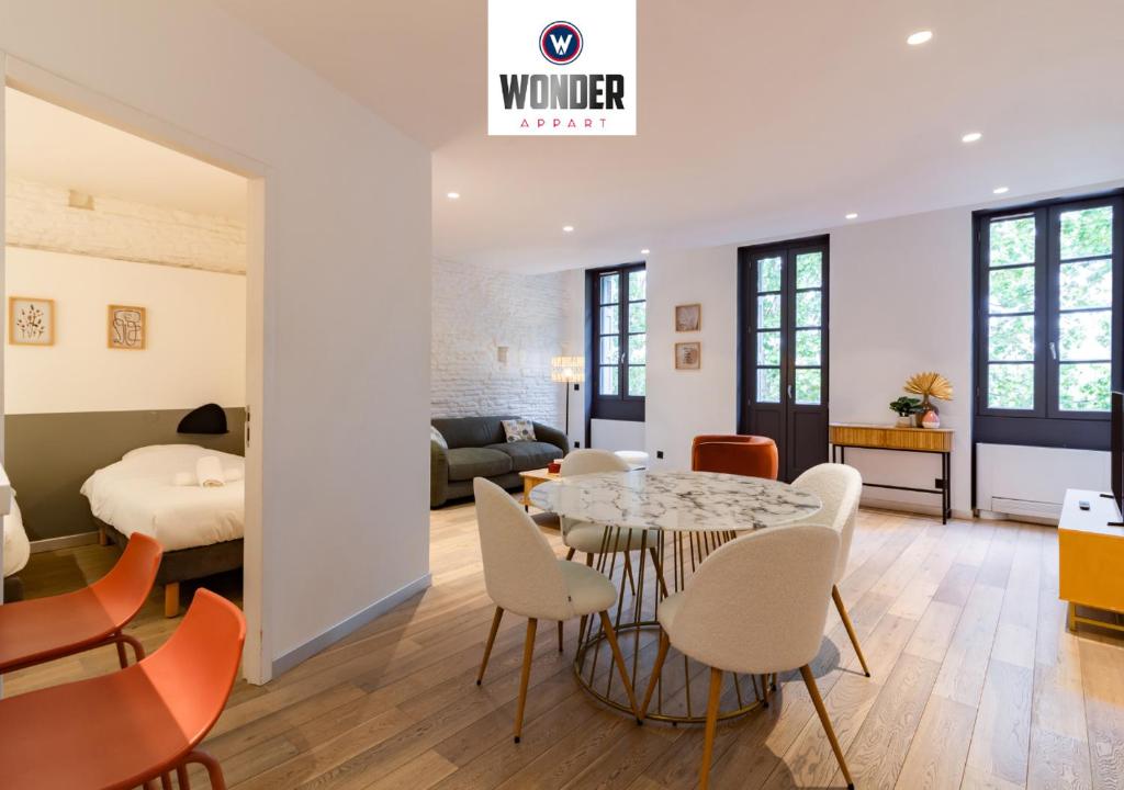 トゥールーズにある404 · Wonder Appart - Vue Garonne -のテーブルと椅子、ベッドルーム1室が備わります。