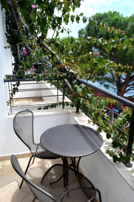 a table and two chairs on a balcony at Hotel Cala Luna in Cala Gonone