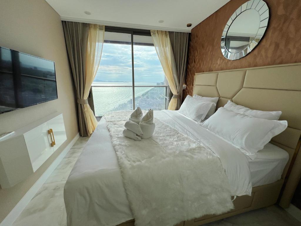 Un pat sau paturi într-o cameră la Copacabana Jomtien Beach Condo 中天海滩寇芭酒店公寓