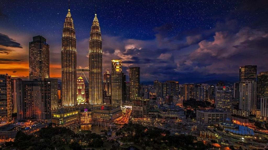 een skyline van de stad met de petronas torens 's nachts bij Premium Getaways in Kuala Lumpur