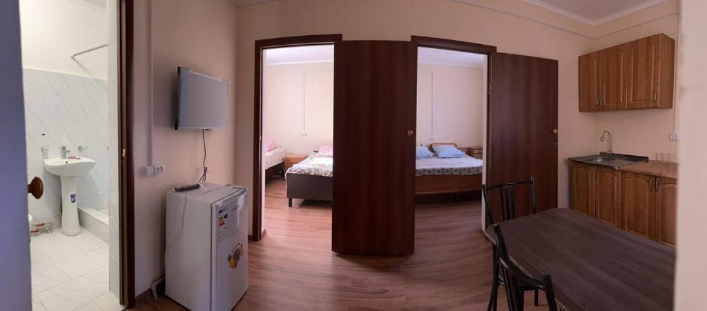 a room with a room with a bedroom with a bed at 4-местные домики in Balqash
