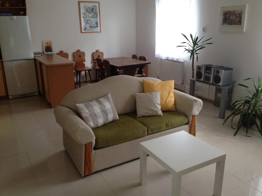 a living room with a couch and a table at Wypoczynek na Kurpiach in Kadzidło