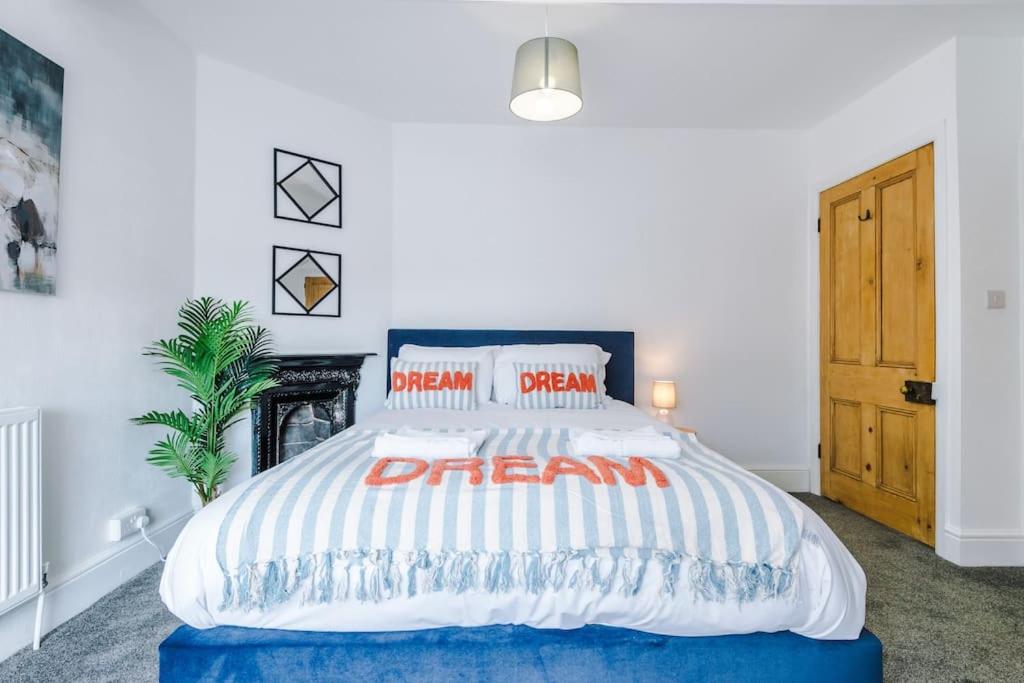 a bedroom with a large bed with red and white pillows at 2-Bed Victorian Oasis in Chester in Chester