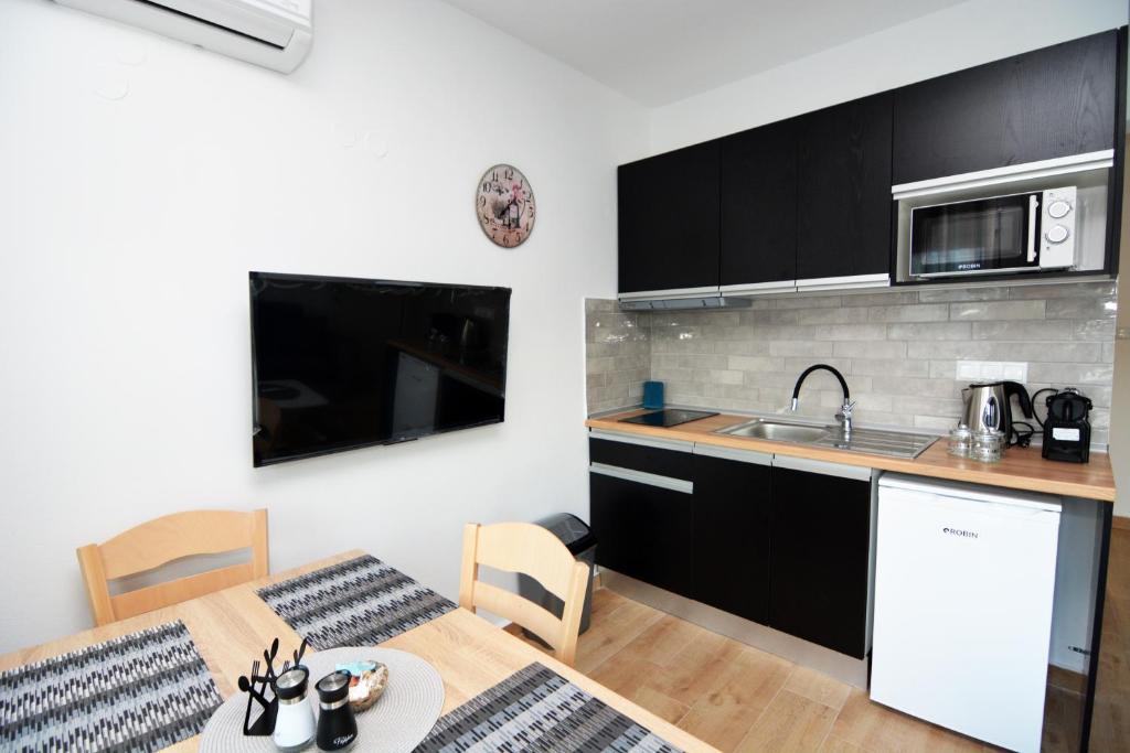 a kitchen with a table and a kitchen with a sink at Blue Lagoon 3 in Kavala