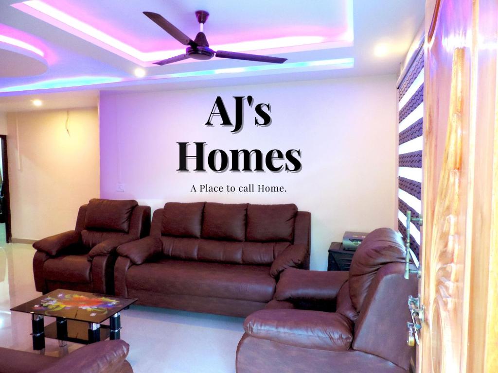 a living room with aahs homes sign on the wall at AJ's Home in Port Blair