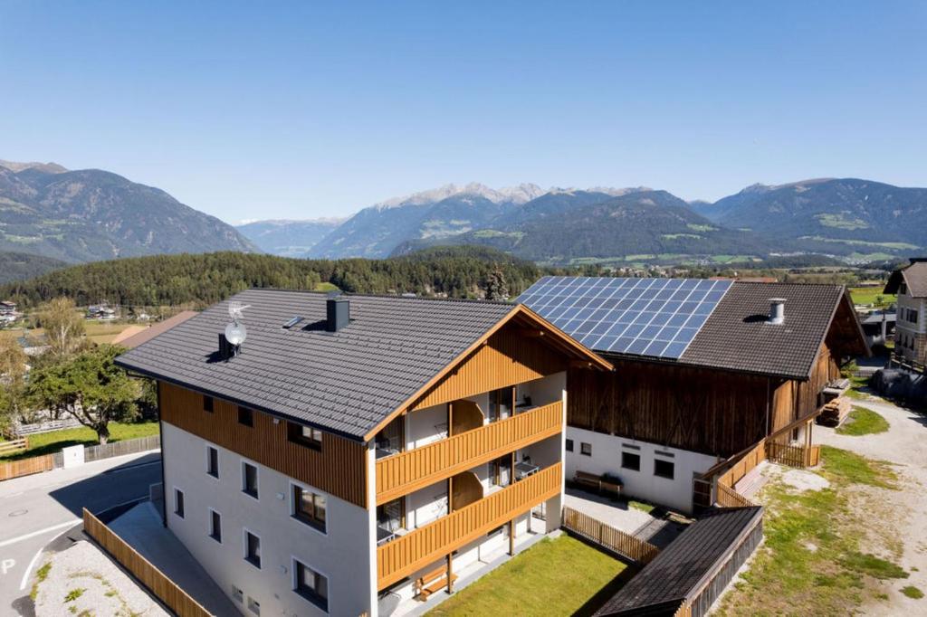 an image of a house with solar panels on the roof at Obergasserhof Apt Waldruhe in Riscone