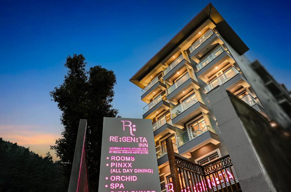 a building with a sign in front of it at Regenta Inn Luxinna Heights Mcleodganj in Dharamshala
