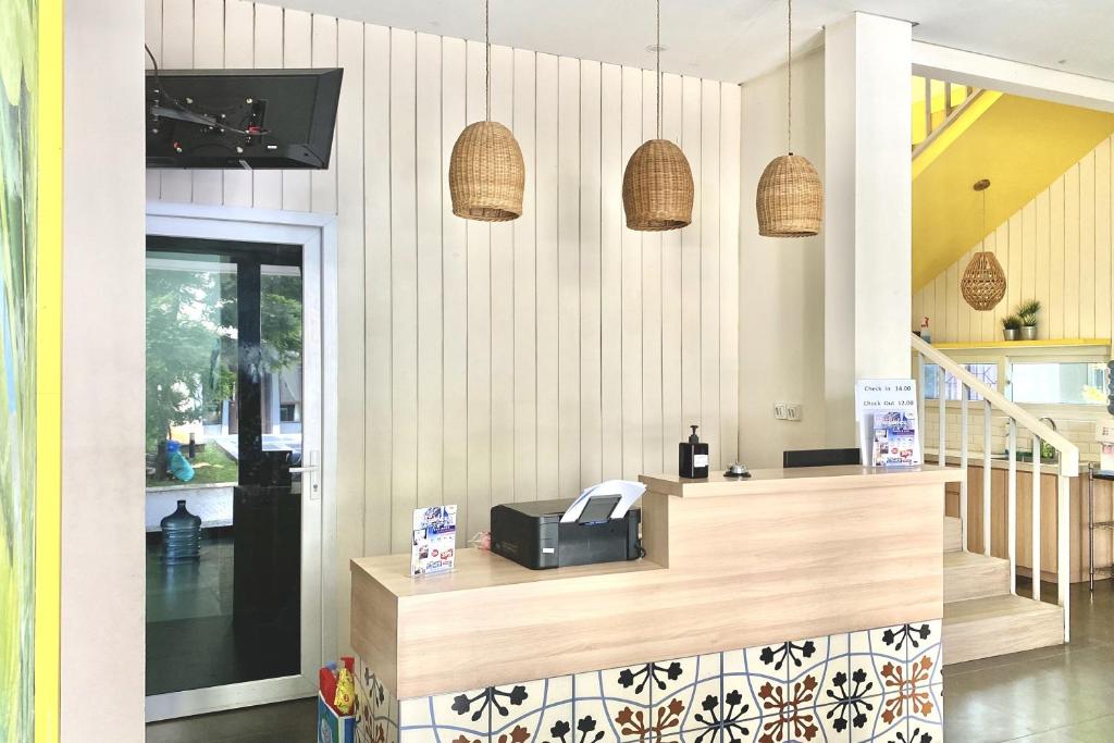 a store with a counter with a cash register and pendant lights at 3C Residence in Tangerang