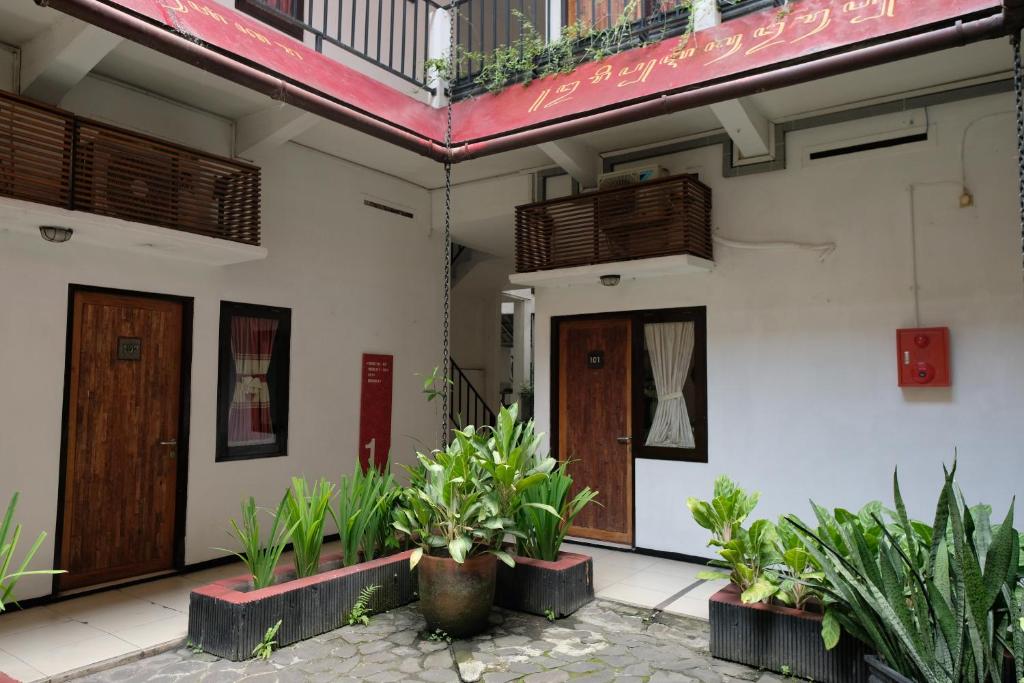 un edificio con due porte e piante davanti di Mawar Asri Hotel a Yogyakarta
