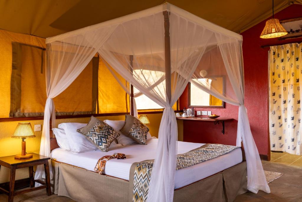 Postel nebo postele na pokoji v ubytování Sentrim Tsavo Lodge
