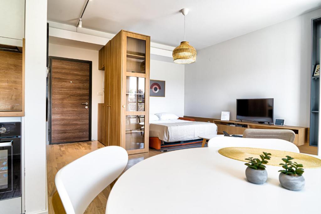 a bedroom with a bed and a living room at The Riverscape in Podgorica