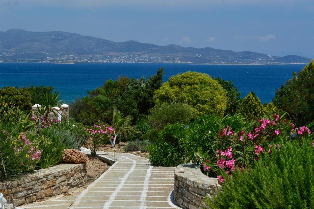 a garden with a stone pathway and flowers at Villa Peristeri in Agios Georgios