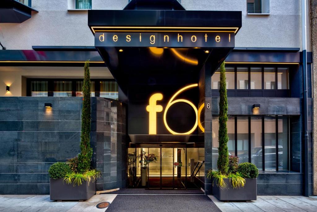 un ingresso anteriore di un edificio guado con un cartello sopra di Design Hotel f6 a Ginevra