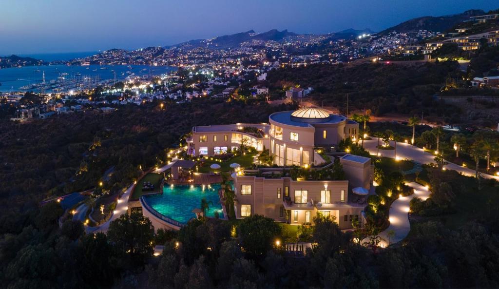 an aerial view of a mansion with a pool at night at Ailla Yalıkavak in Bodrum City