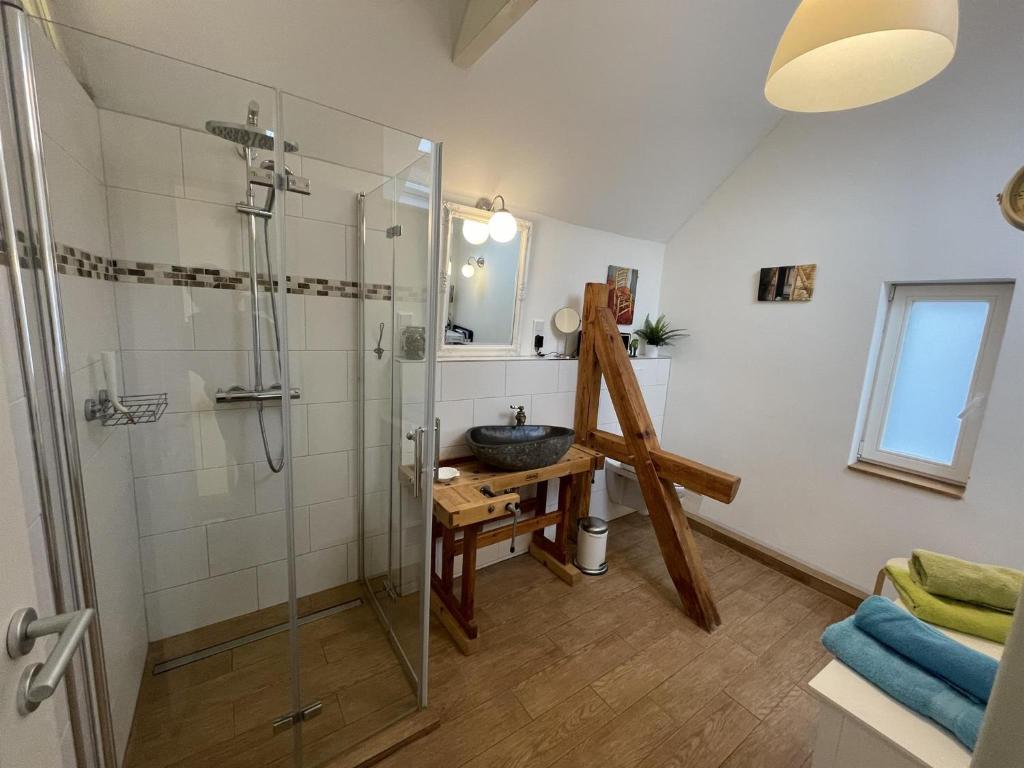a bathroom with a glass shower and a sink at Ferienhaus Alte Schmiede in Kirchhain