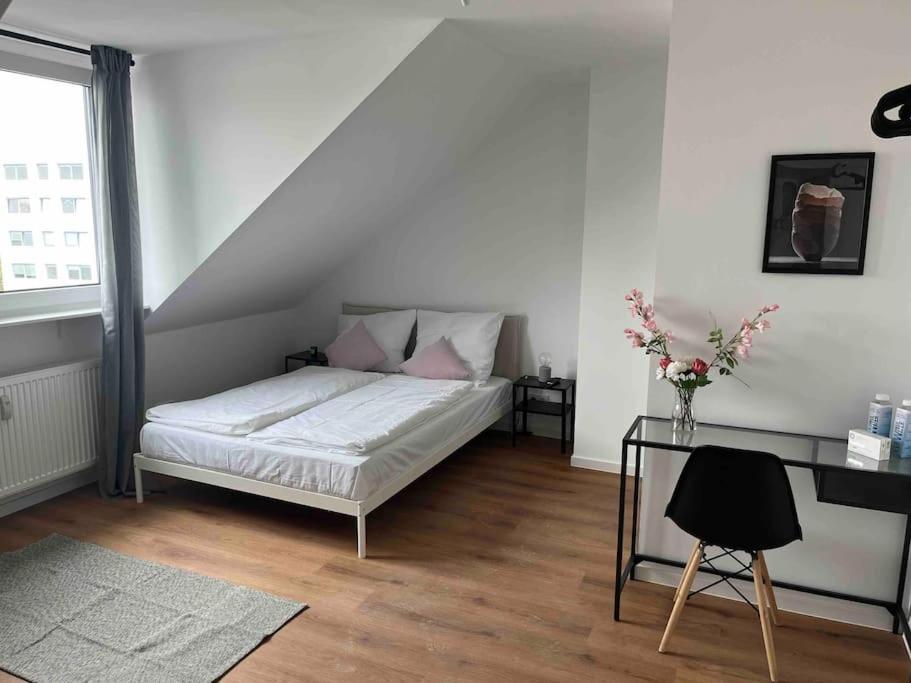a white bedroom with a bed and a desk at Design Wohnung im Zentrum von Koblenz in Koblenz