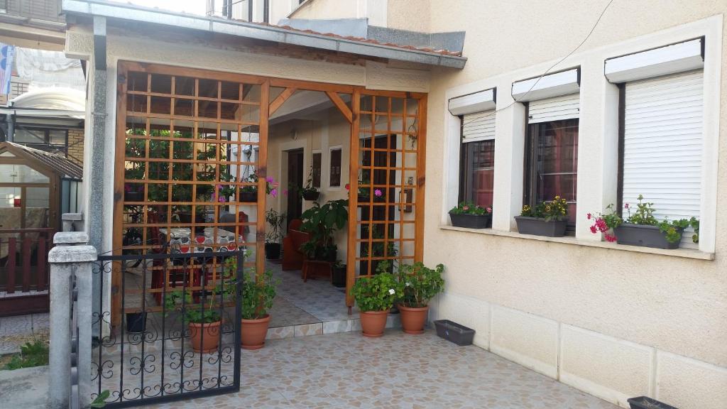 a store with potted plants on the side of a building at House Kostoski in Ohrid